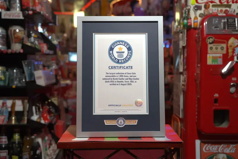 The Guinness World Records certificate for the largest collection of Coca-Cola memorabilia, framed in the Coca-Cola room